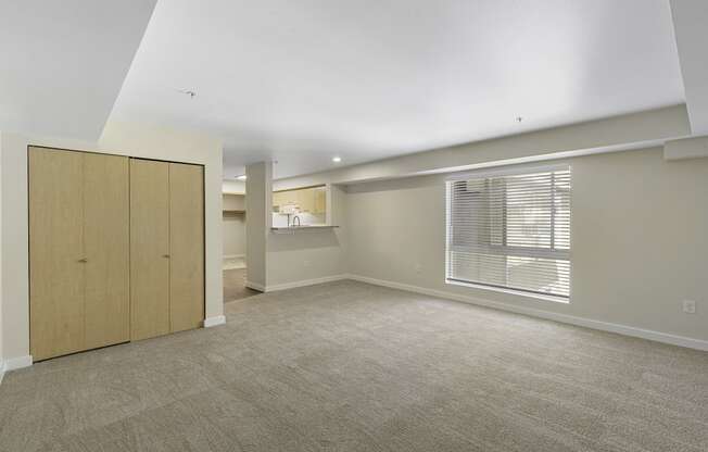 Spacious Living Area with a Coat Closet and a Large Windows to View Outside Area at Excalibur Apartment Homes, Washington