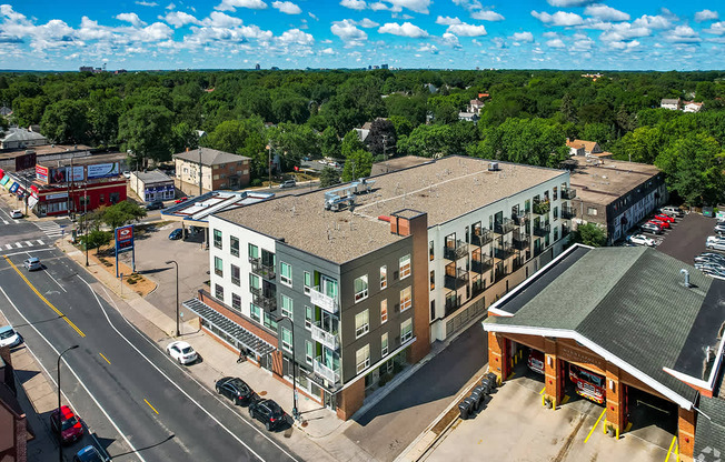 A street view of a town with a large building in the center.