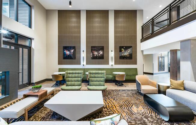 Multi-level resident lounge with layered seating, curated art, and warm finishes designed for gathering, conversation, and everyday connection.