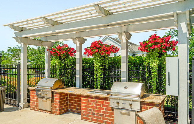 a patio with a barbecue grill and a pergola