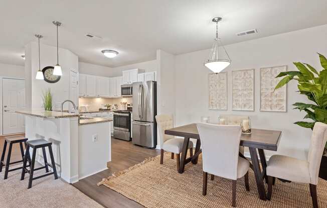 an open kitchen and dining room with a table and chairs