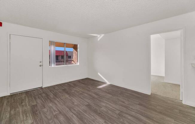 A room with a wooden floor and white walls. at Urban WalkApartments on 6th Avenue, Arizona 85016