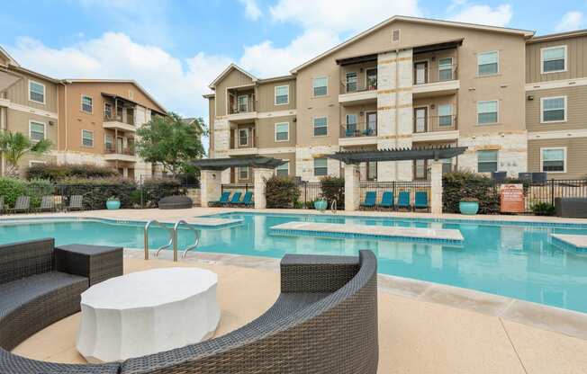 our apartments have a large swimming pool with chairs and tables
