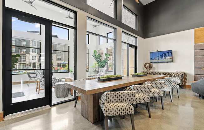 a dining room with a long wooden table and chairs