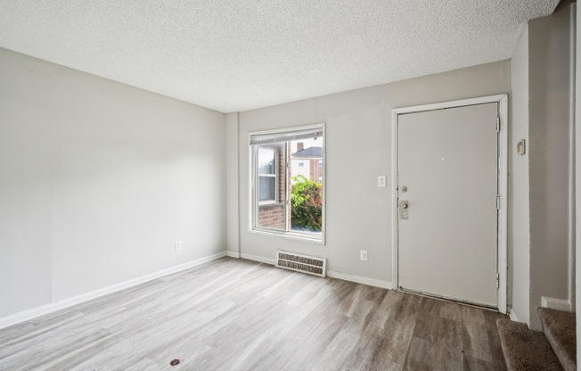 A room with a window and a door.