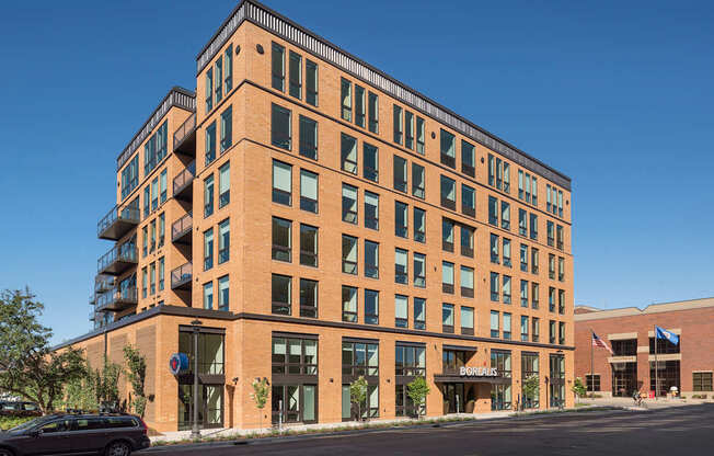 A large brick building with a balcony on the top floor.
