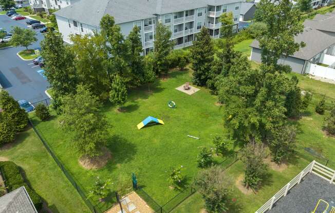 an aerial view of a backyard with a trampoline