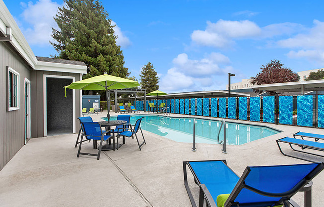 Community Swimming Pool with Pool Furniture at Meritage Apartments in Vallejo, CA.