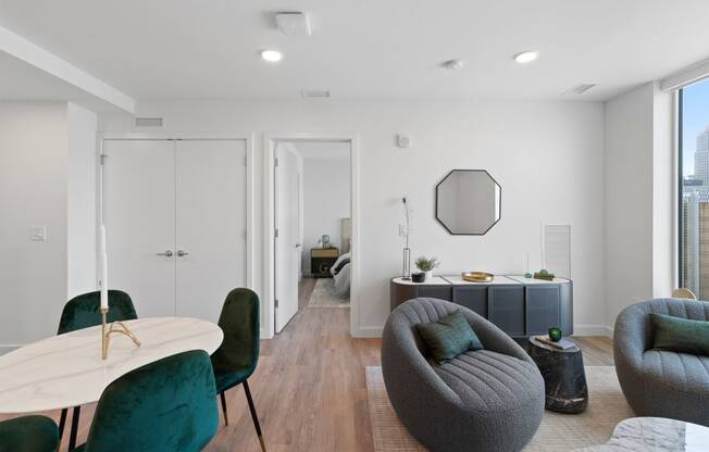 a living room with a couch and a table and chairs