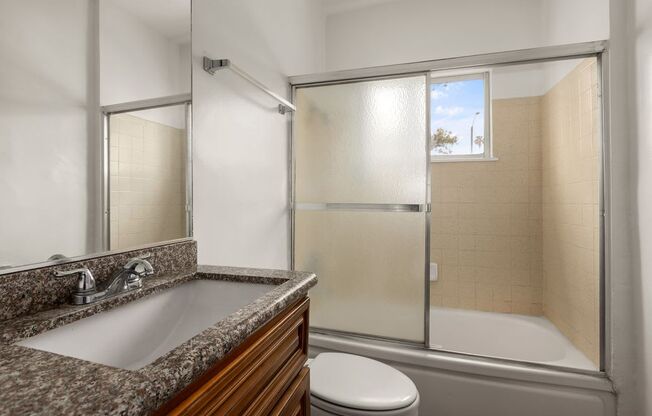 a bathroom with a sink toilet and shower