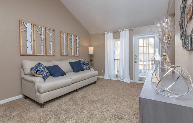 a living room filled with furniture and a large window