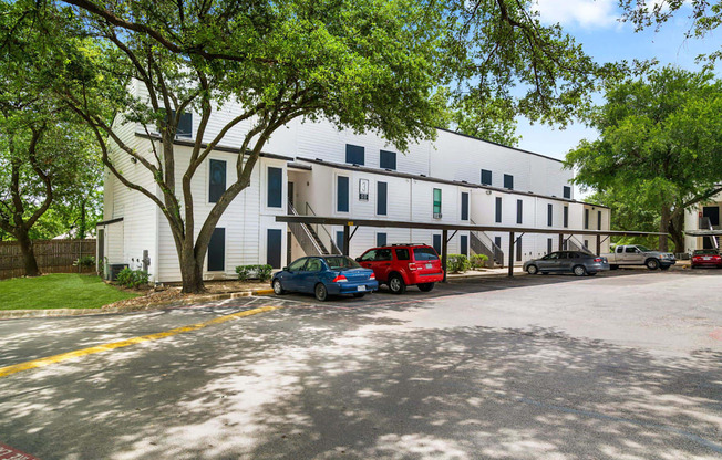 a large white building with cars parked in front of it