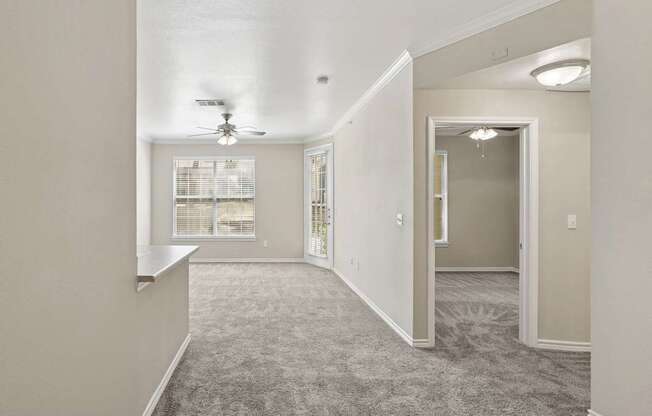 Edinburgh living room  with a carpeted floor and a ceiling fan at Encore at Buckingham Apartments in Richardson, TX