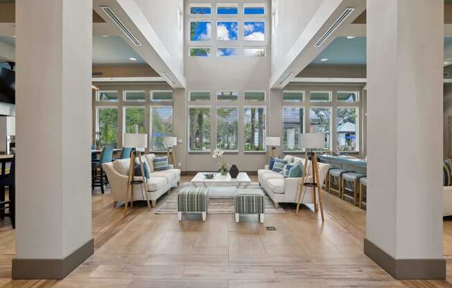 a living room filled with furniture and windows