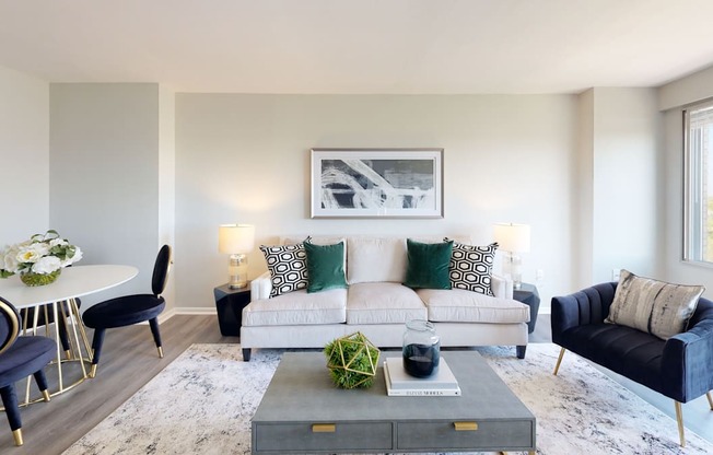 a living room with a couch coffee table and dining table