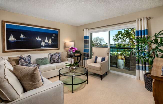 a living room filled with furniture and a large window