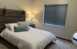 Furnished bed room with full size bed at north pointe villas in lincoln nebraska
