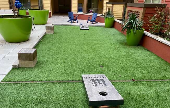 a yard with artificial turf and a memorial on it