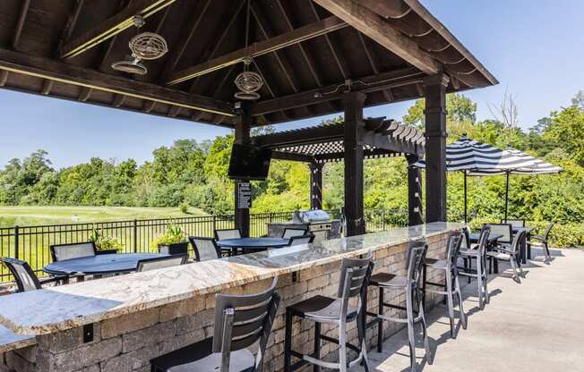 a bar with chairs and tables under a pavilion