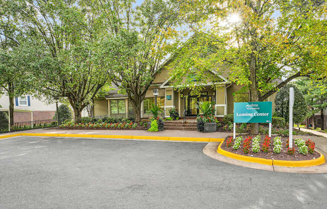 A leasing center is surrounded by trees and plants.