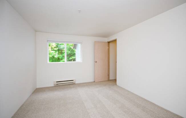 a white room with a window and a door
