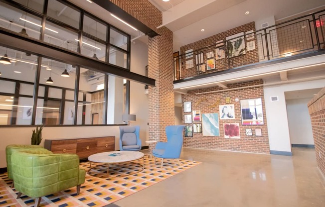 The main lobby at Penstock Quarter apartments in Henrico VA features a two story gallery wall and impressive brick details.