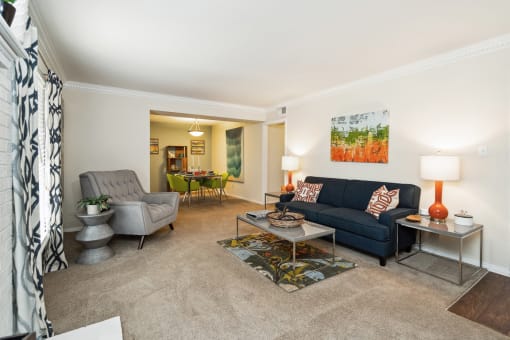 a living room with a blue couch and two chairs  at Lake Johnson Mews, Raleigh, NC, 27606