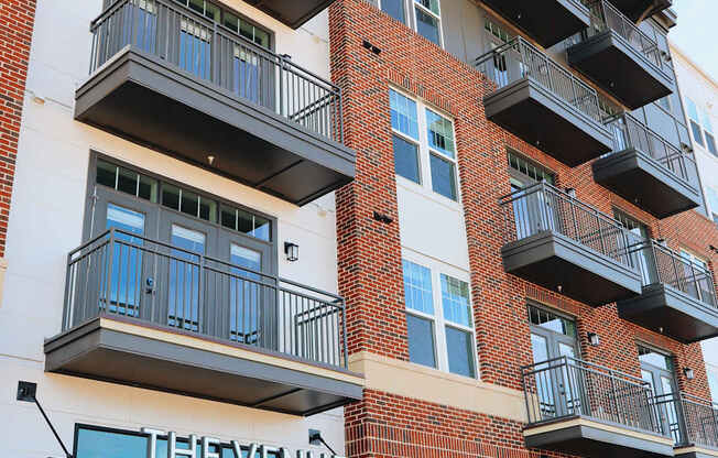 The Venue on South Main is a multi-story apartment building with balconies and large windows.