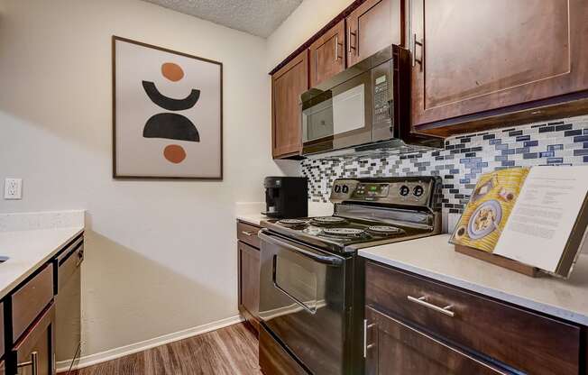 a kitchen with wood cabinets and stainless steel appliances