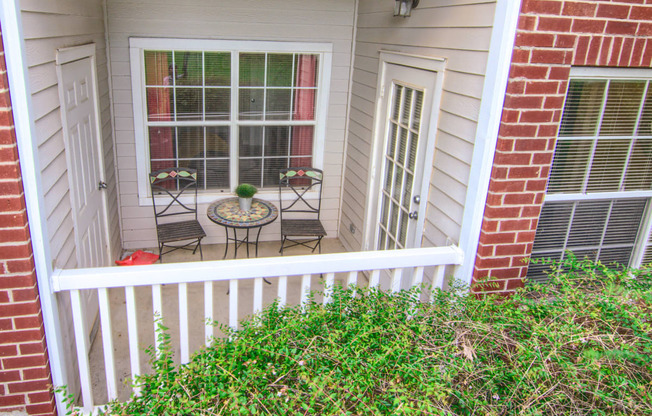 Enclave at Wolfchase Apartments in Cordova Tennessee photo of a small porch with a small table and two chairs