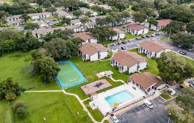 an aerial view of a neighborhood with houses and a swimming pool