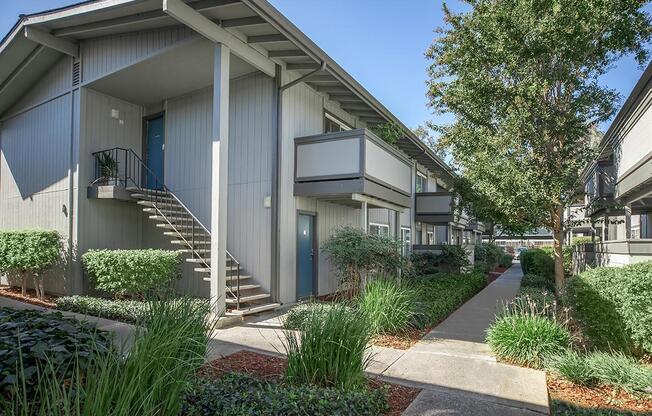 a house with bushes in front of a building