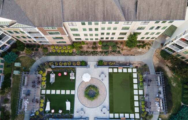 A large building with a green lawn in front of it.
