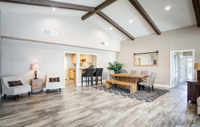A spacious living room with a wooden floor and a high ceiling.