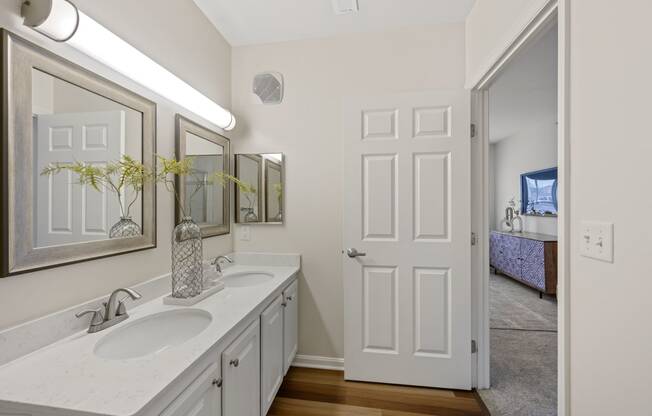 a bathroom with two sinks and a mirror