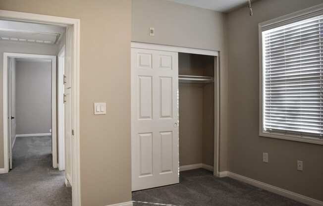 view of closet and hallway leading to second bedroom