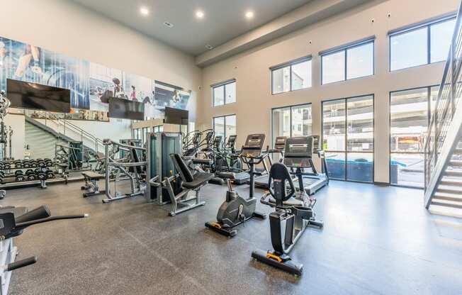 Fitness Center With Outside View at Residences at 3000 Bardin Road, Grand Prairie, TX, 75052