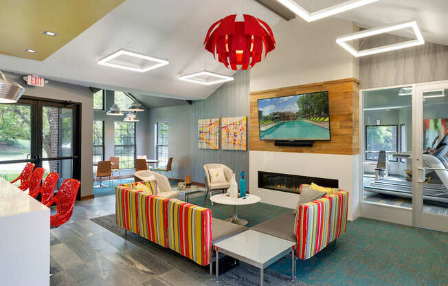 Community Room with seating, a full kitchen, and lounge chairs at Eden Commons in Eden Prairie, MN 55344