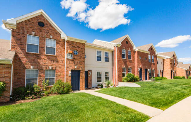 A row of houses with a clear blue sky above them.