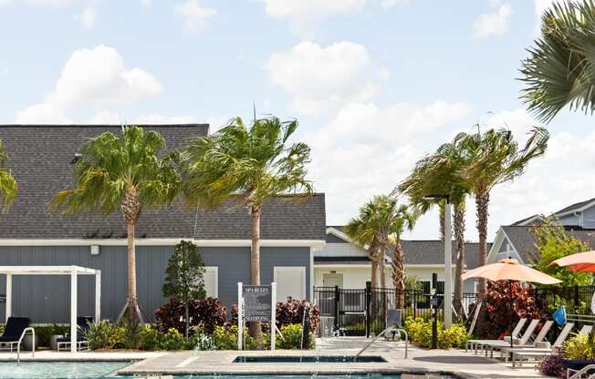 a swimming pool with chairs and a fire pit at The Sophia, Venice, FL, 34275
