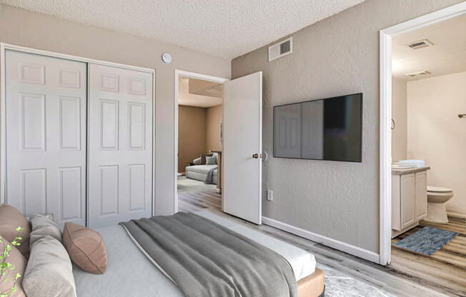 a bedroom with a tv on the wall