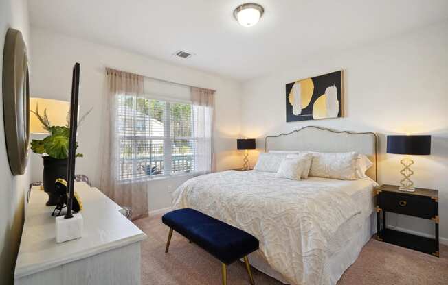 Bedroom with a bed and a dresser and a window  at The Meadows, Bloomingdale, GA, 31302