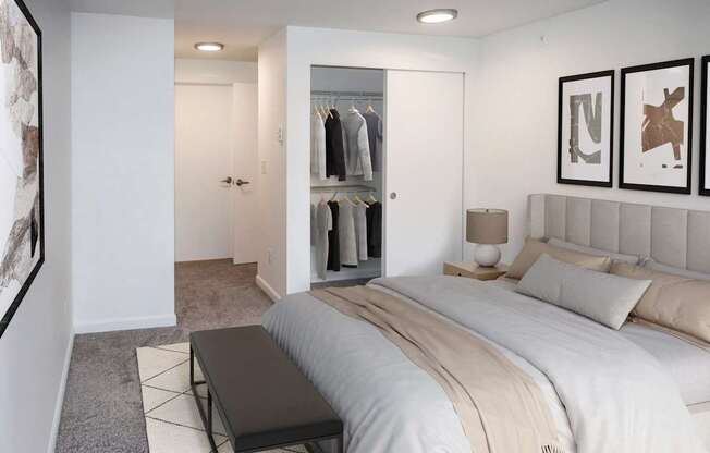 A bedroom with a large bed and a walk-in closet at Heritage Grove in Renton.