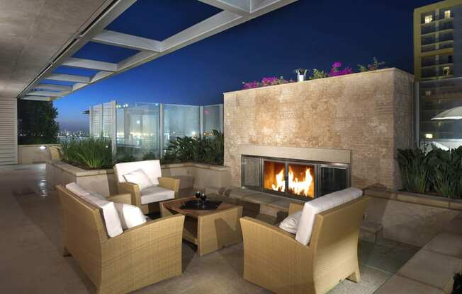 a fireplace on the terrace of a luxury condo at night