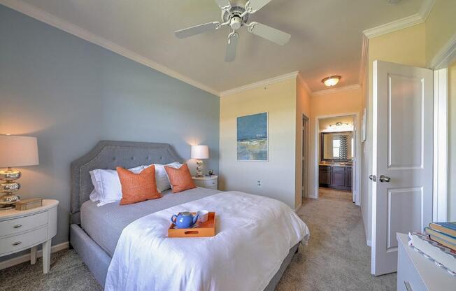 a bedroom with a bed and a ceiling fan