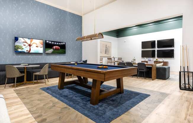a rec room with a pool table and a tv