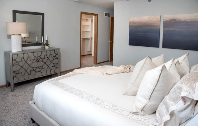 master bedroom with vaulted ceiling and california closet