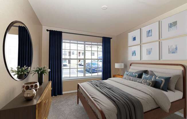 A bedroom with a large bed and a window with blue curtains.