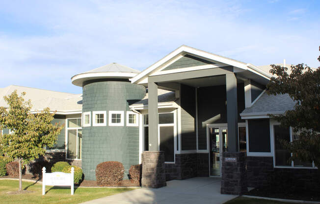 the front of a building with a white bench in front of it