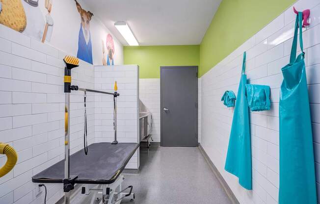 A room with a table and a wall with pictures.